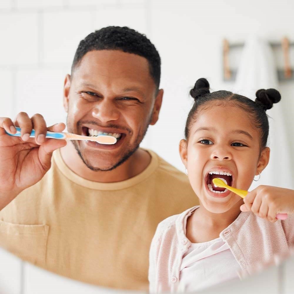 Father and Young Daughter brushing their teeth